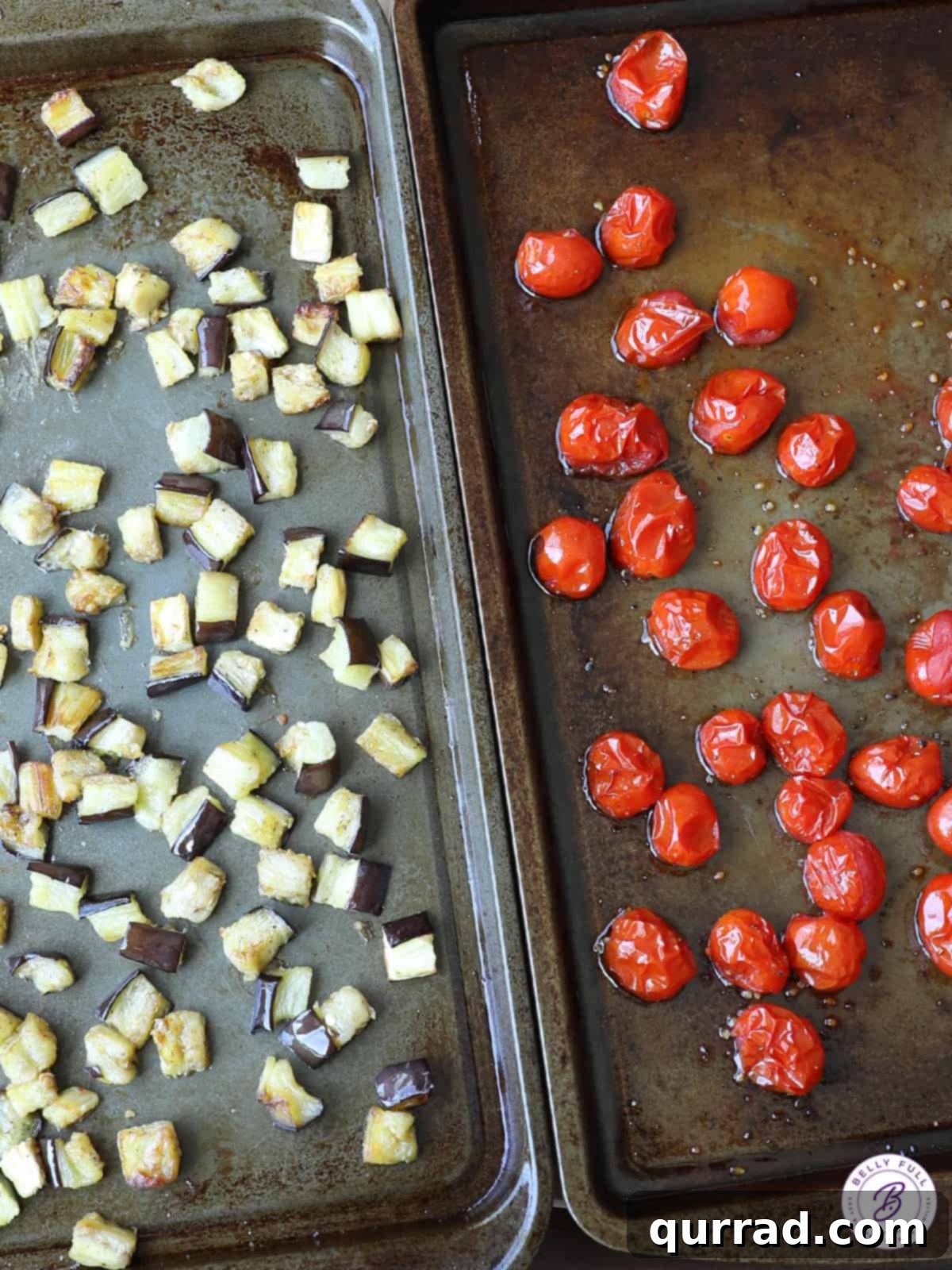 Savory Roasted Eggplant and Sweet Cherry Tomatoes 3 sheet pan filled with diced eggplant and halved cherry tomatoes ready for roasting in the oven