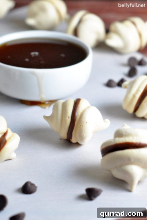 Heavenly Chocolate Meringues 3 chocolate meringue cookies neatly arranged on parchment paper, ready to be cooled