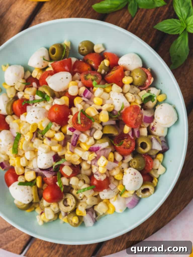 overhead caprese corn salad in serving bowl, showcasing fresh ingredients