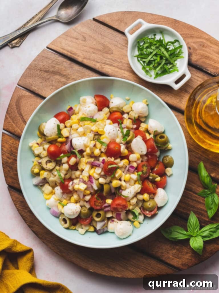 overhead corn salad with tomatoes and mozzarella in serving bowl, vibrant and fresh