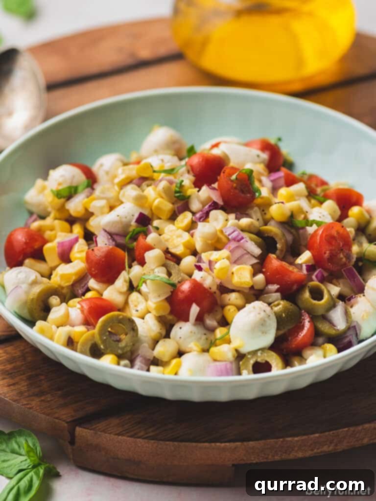 corn salad with cherry tomatoes and green olives, showing the texture and freshness