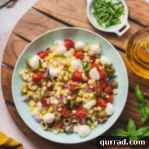 overhead corn salad with tomatoes and mozzarella in serving bowl