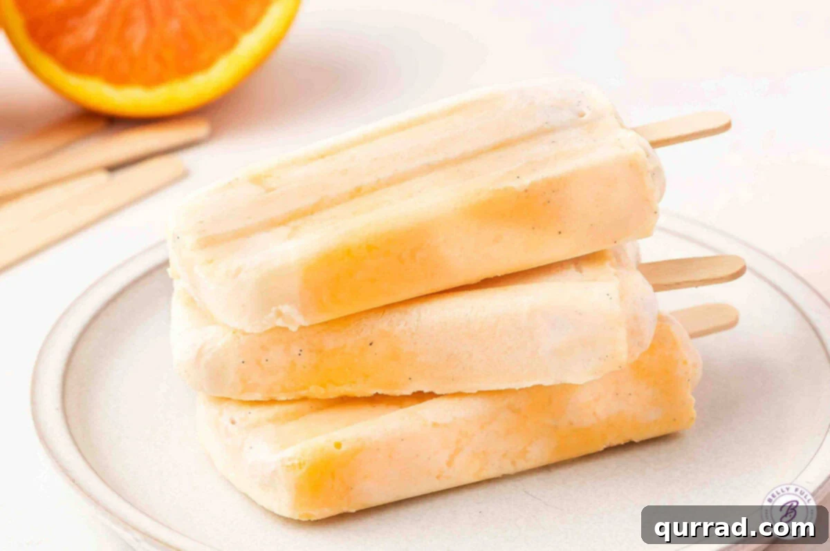 Citrus Cream Dream 8 Three homemade orange creamsicles arranged artfully on a plate.