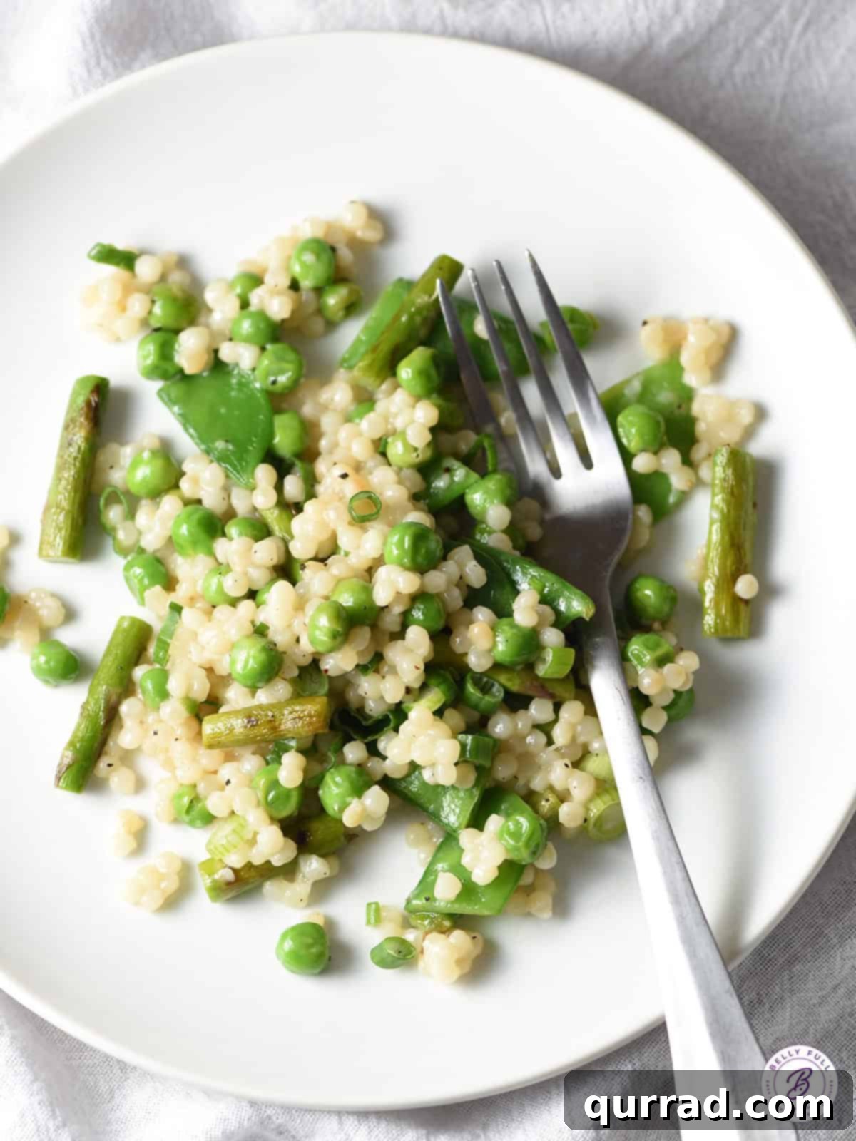 Spring Harvest Couscous 2 couscous with asparagus and baby peas, served in a bowl