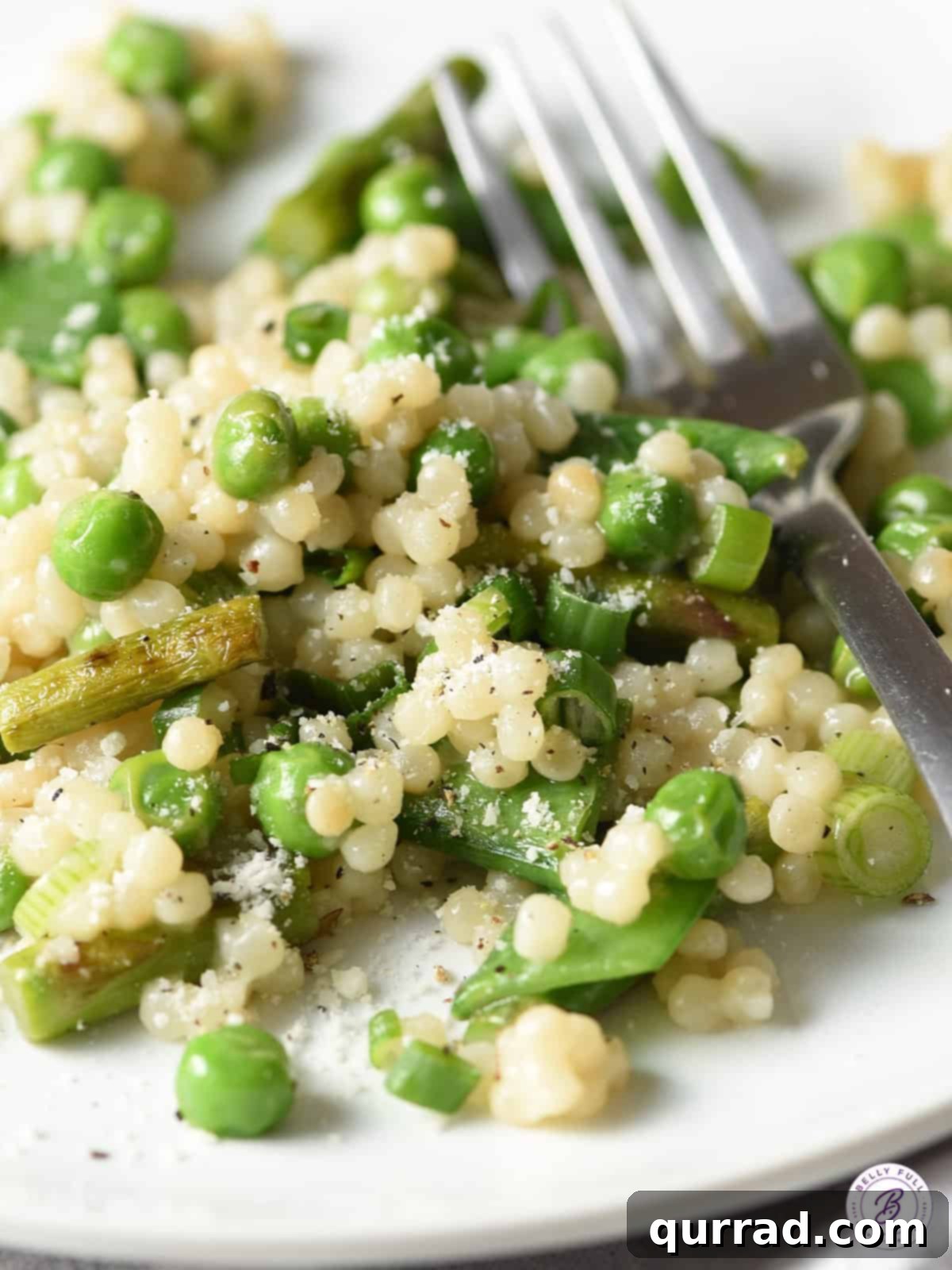 Spring Harvest Couscous 4 close up view of couscous with baby peas on a white plate