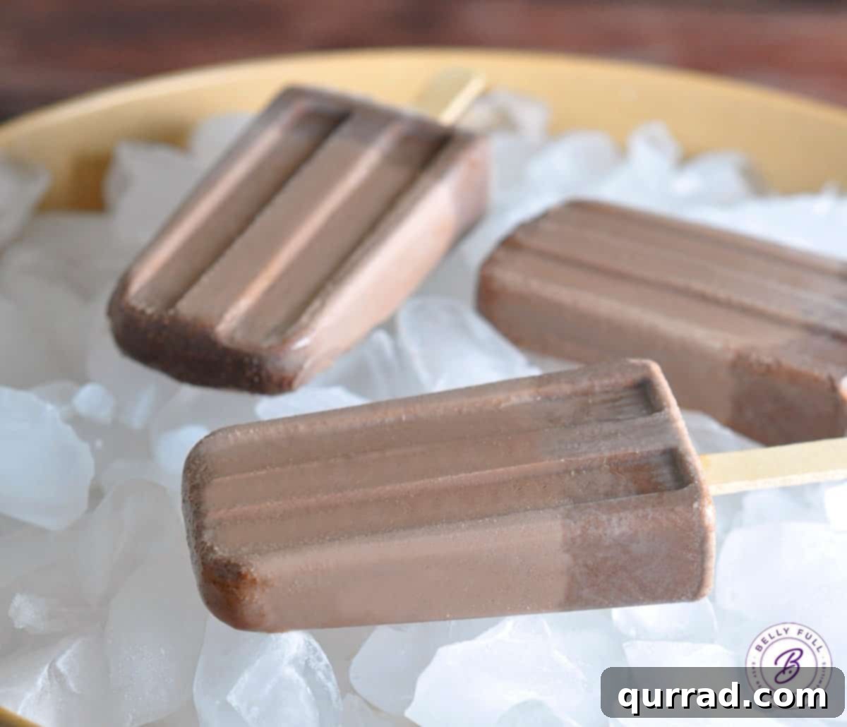 Mexican Spice Chocolate Paletas 3 Mexican Fudgesicles laying on ice cubes