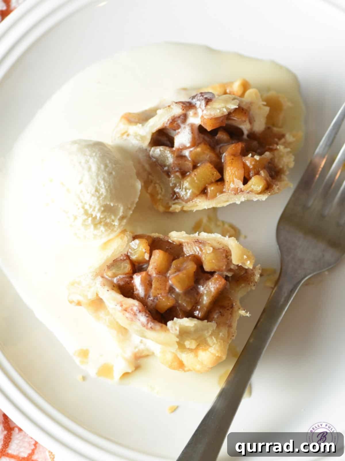 Bite-Sized Peach Delights 3 Overhead shot of a baked hand peach pie, cut in half to reveal its warm, juicy peach filling and golden crust.