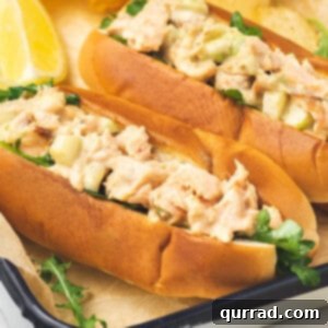 close up hot dog bun stuffed with salmon salad