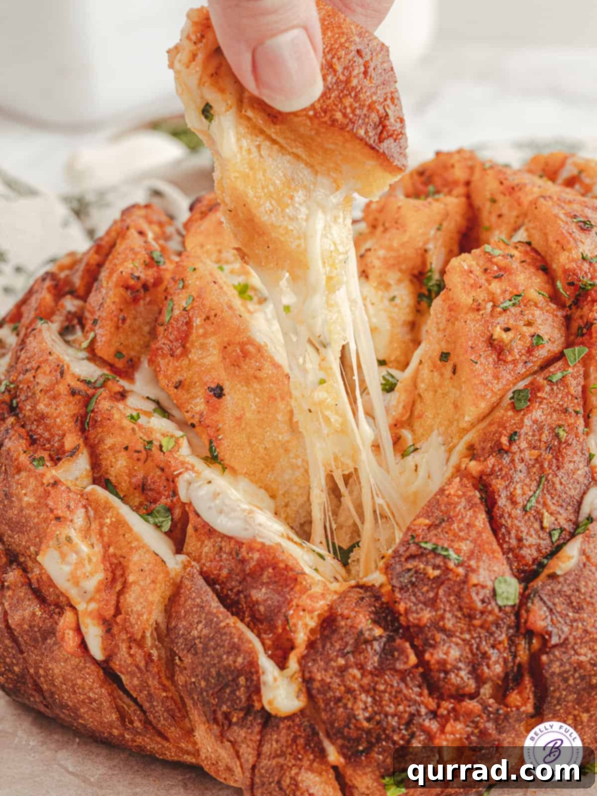 boule sourdough bread loaf with cheese pull