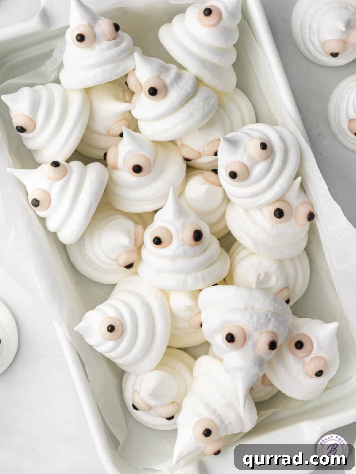Spectral Meringue Kisses 2 serving tray filled with Meringue Cookies that have candy eyes as ghosts