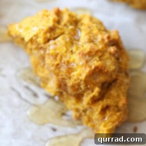 half a pumpkin drop biscuit drizzled with honey