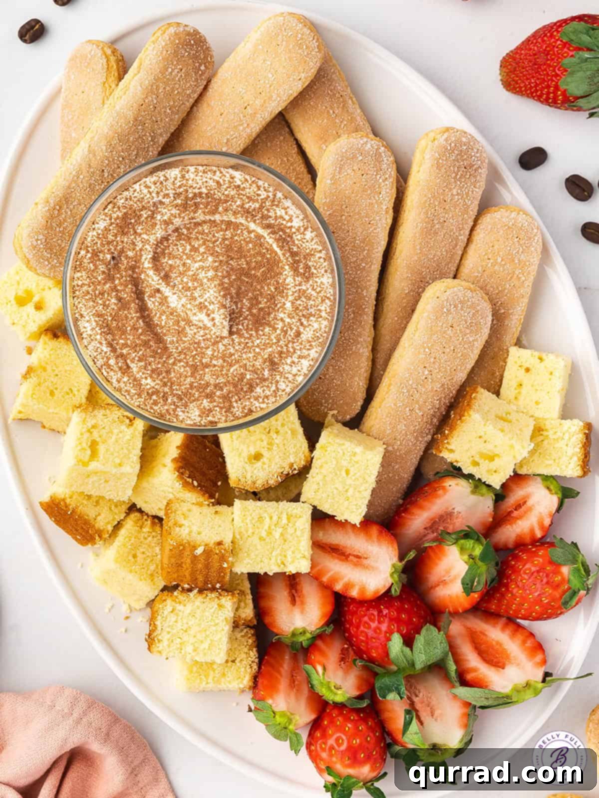 Decadent Tiramisu Dip 4 overhead Tiramisu Dip on serving tray with with ladyfingers, pound cake cubes, and strawberries for dippers