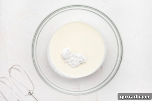 Decadent Tiramisu Dip 6 heavy cream and powdered sugar in glass mixing bowl