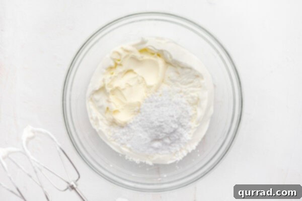 Decadent Tiramisu Dip 7 whipped cream, mascarpone cheese, and powdered sugar in glass mixing bowl