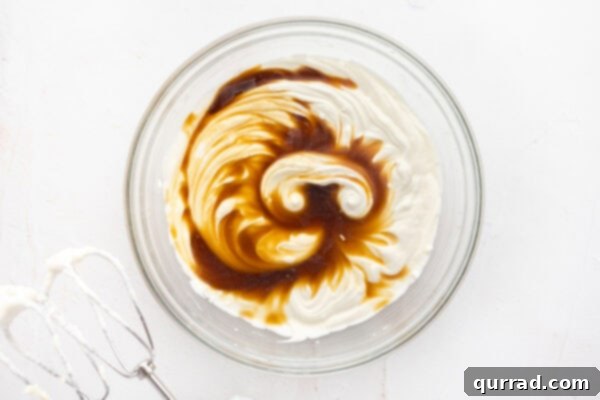 Decadent Tiramisu Dip 8 whipped mascarpone cheese and heavy cream cream with coffee in glass mixing bowl