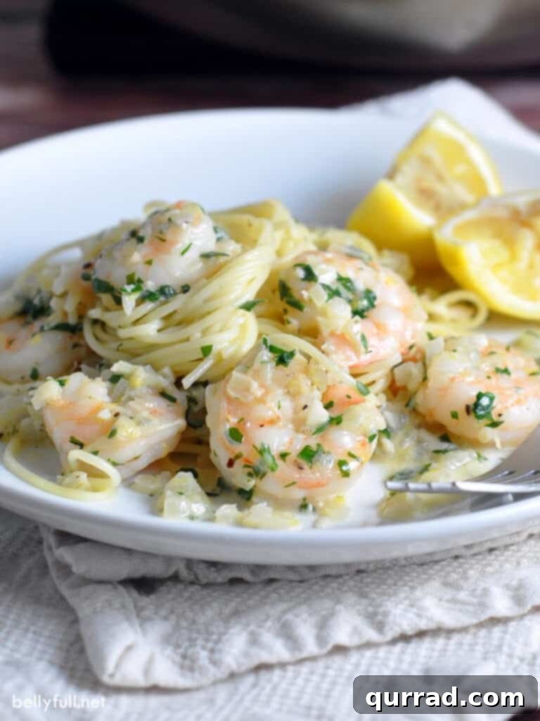 shrimp scampi with pasta on white plate