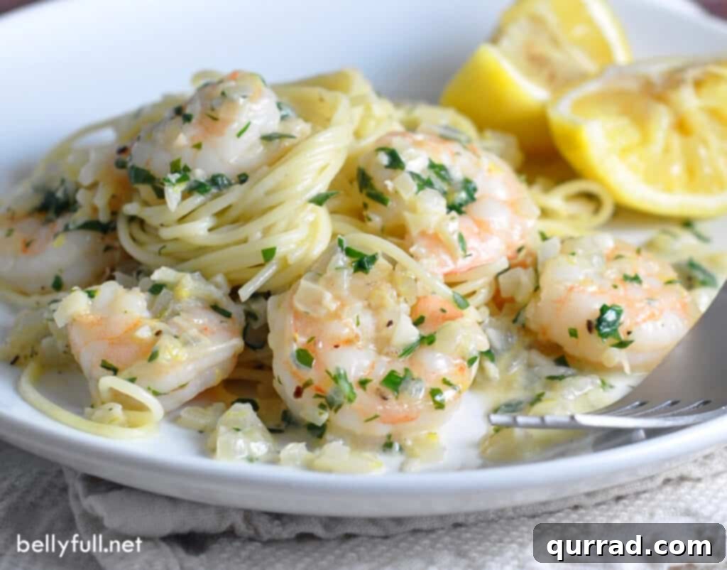 shrimp scampi with pasta on white plate