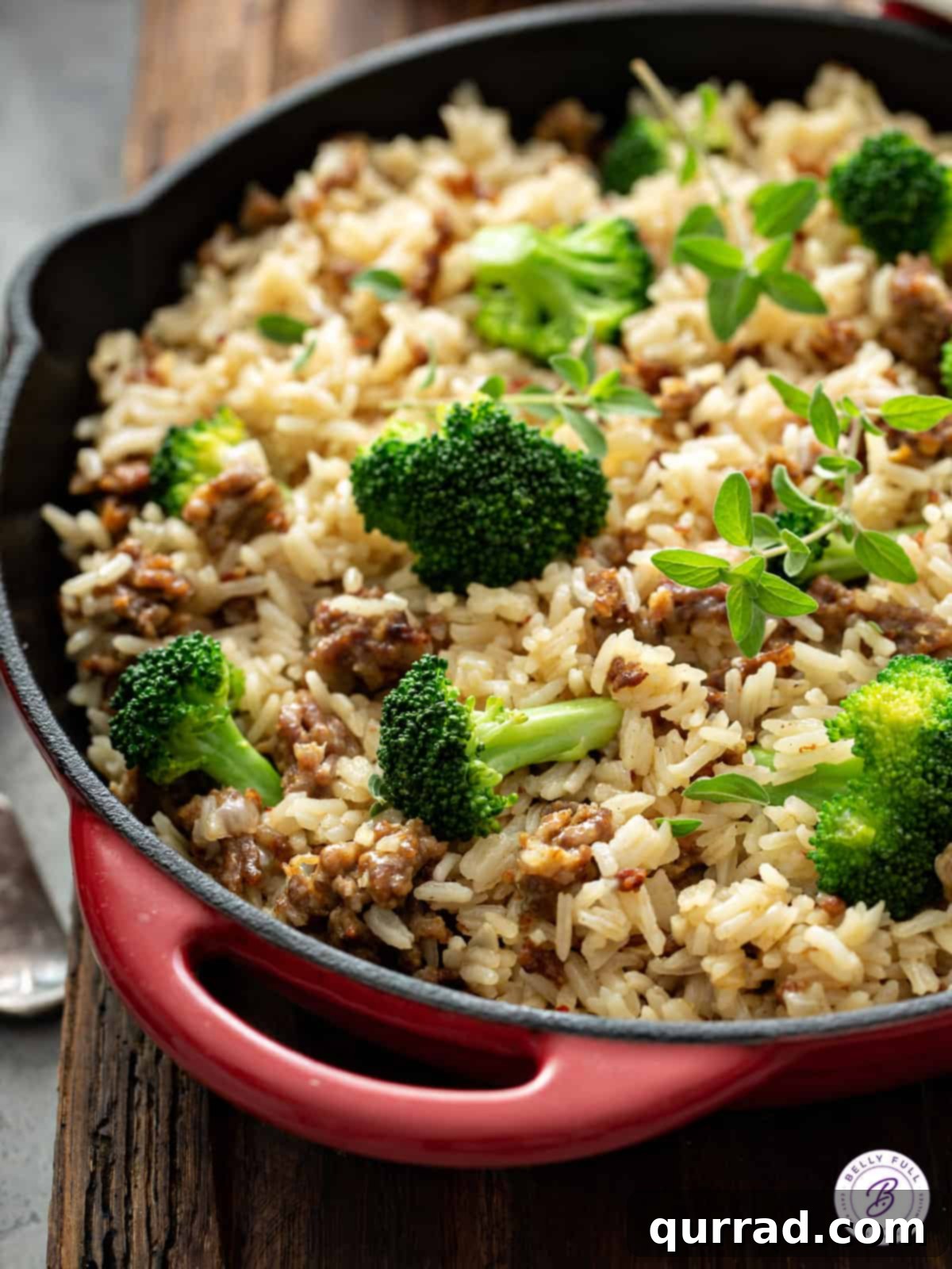 Close-up view of the delicious sausage, rice, and broccoli mixture simmering in a large skillet.