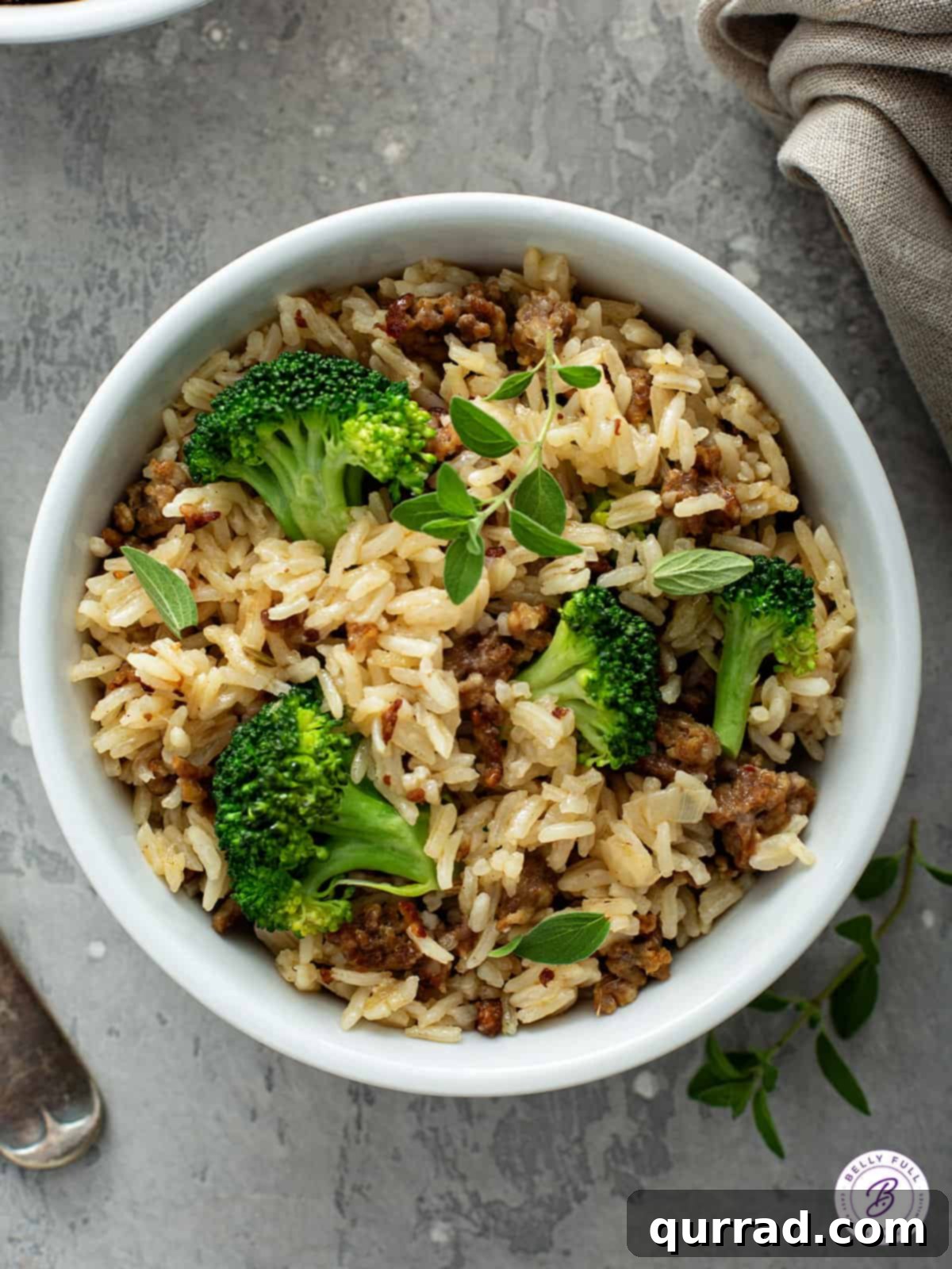 A single serving bowl showcasing the completed, savory one-pot sausage and rice with broccoli, ready to enjoy.