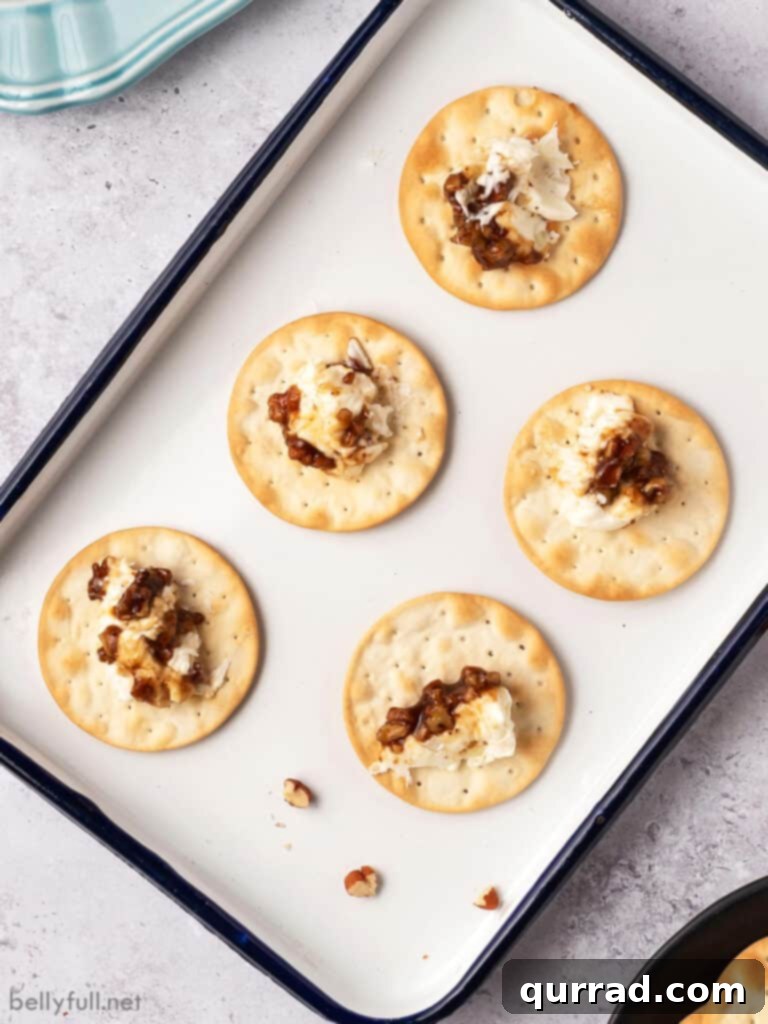 Cream cheese and pecan spread on crackers, ready to be served and savored at a festive event.
