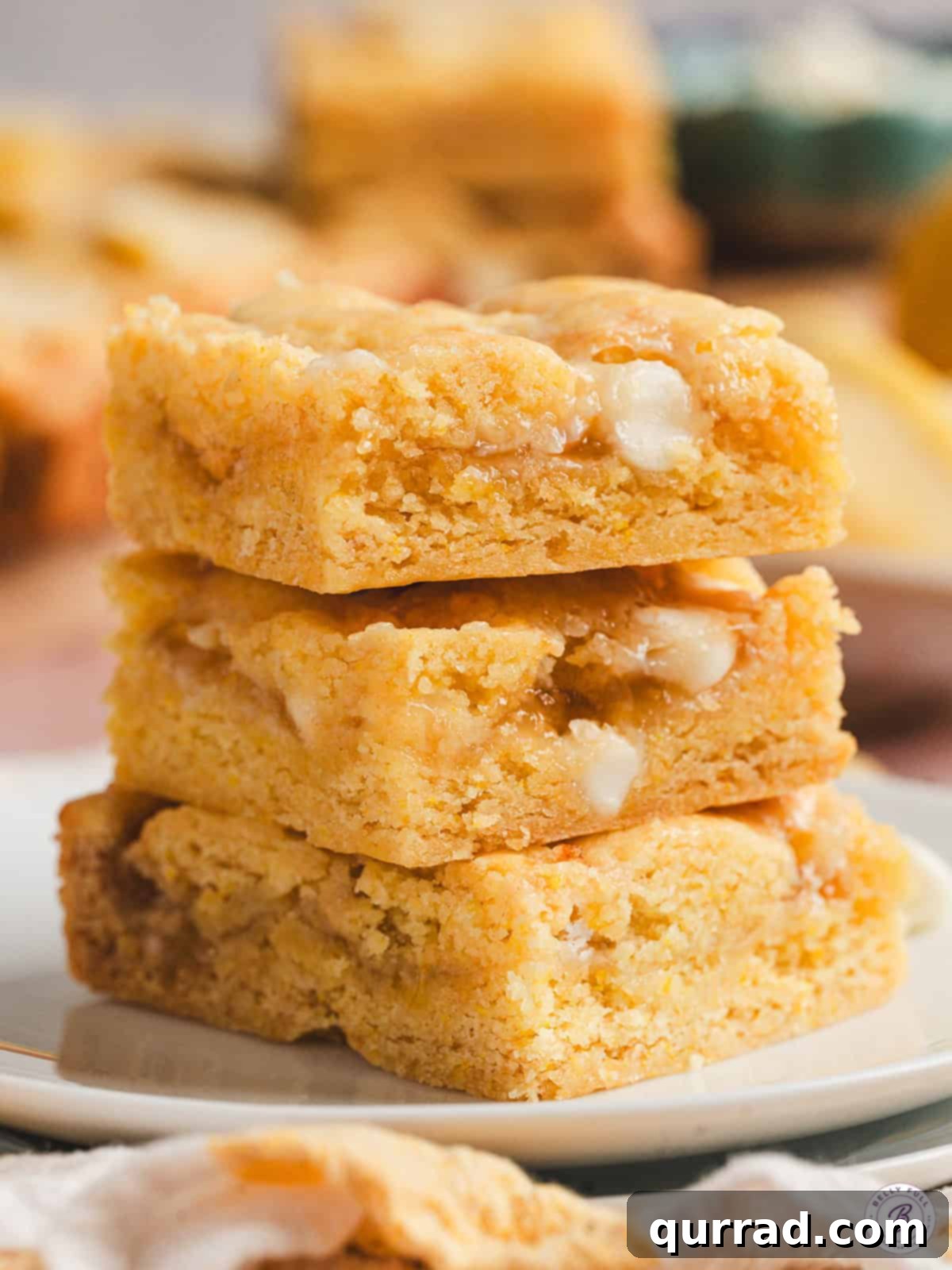 Zesty Lemon Bliss Bars 11 stack of 3 lemon gooey bars, showing the gooey layers