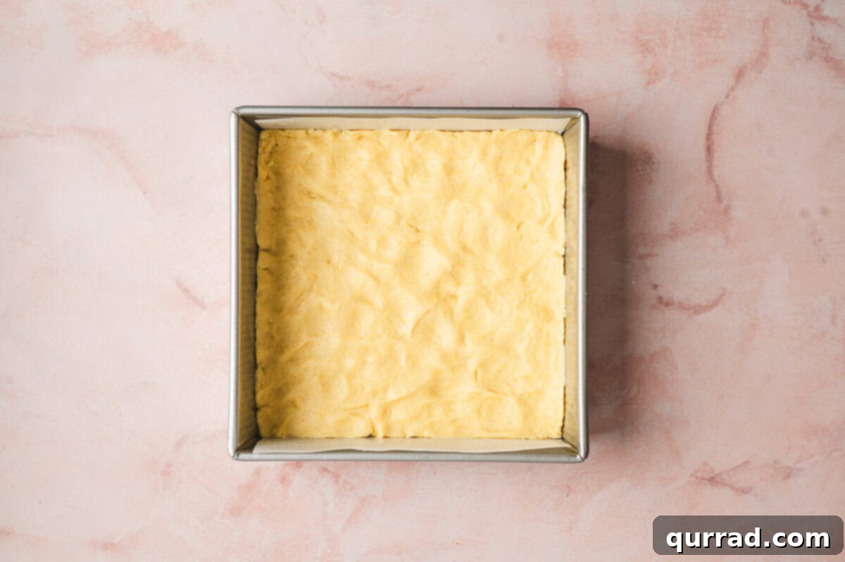 Zesty Lemon Bliss Bars 5 dough pressed into the bottom of a 9x9 square pan