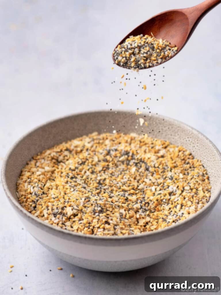 Everything Seasoning Blend 3 seasoning blend falling from spoon into bowl