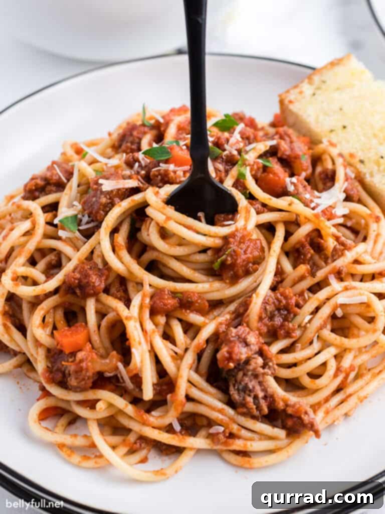Bolognese Sauce 5 cooked spaghetti with meat sauce being swirled with fork