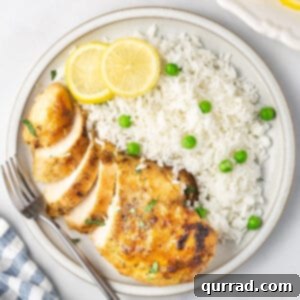 sliced Italian lemon chicken breast with white rice and peas