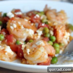 cooked shrimp with tomatoes, peas, and feta cheese