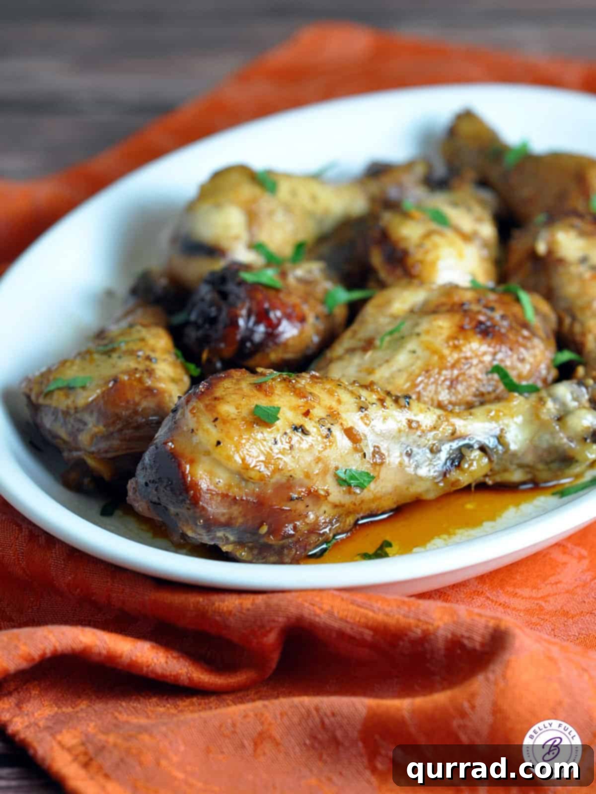 Crockpot Sticky Honey-Soy Chicken 2 Plate of glazed slow cooker honey-soy chicken drumsticks and thighs served with rice and green onions.