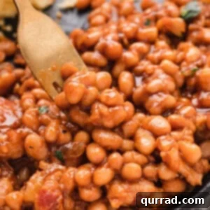 Grandma's Secret Baked Beans 3 forkful of saucy beans with bacon