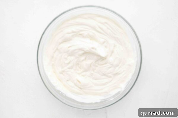 heavy cream whipped to stiff peaks in a glass bowl