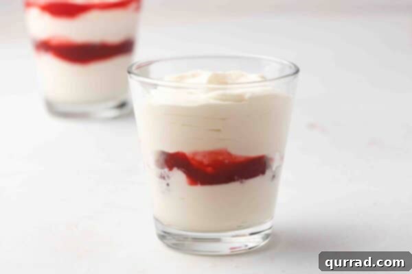 cheesecake mousse and raspberry sauce layered in elegant parfait glasses