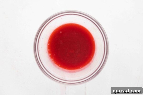 strained, smooth raspberry sauce in a glass bowl