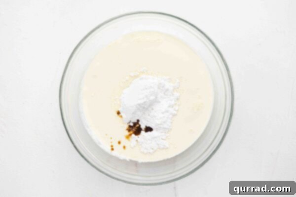 heavy whipping cream, powdered sugar, and vanilla in a large glass bowl