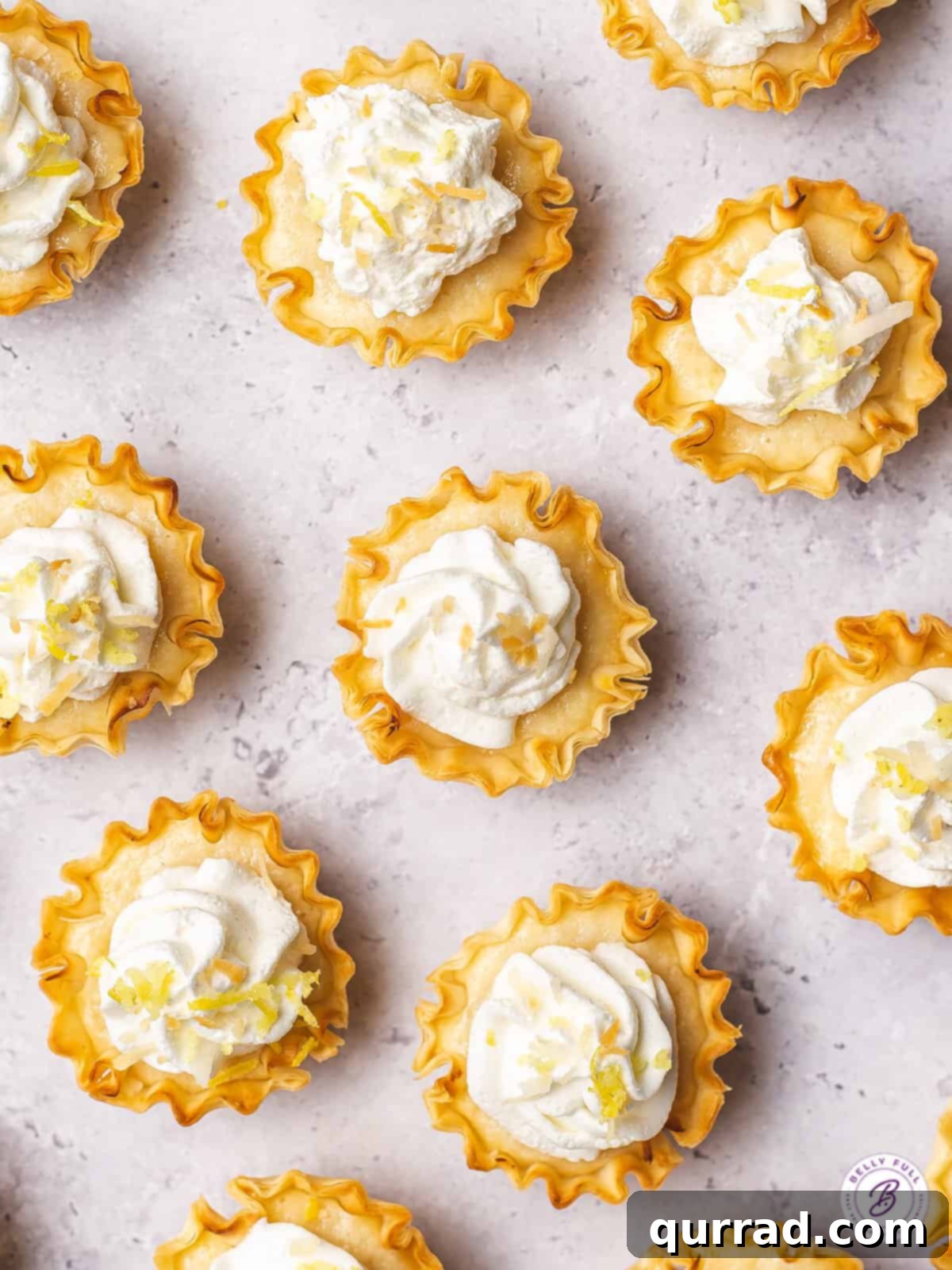 Effortless Tangy Lemon Tartlets 3 overhead mini tarts with whipped cream and toasted coconut