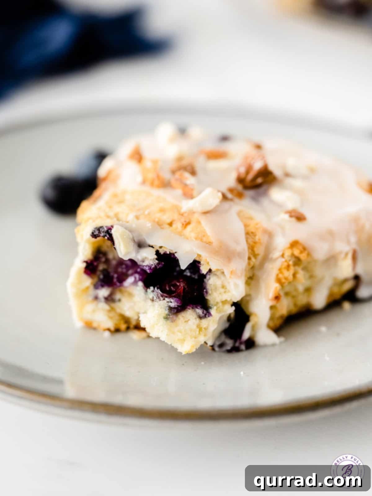 Tender Almond Blueberry Scones 5 A delicious almond blueberry scone cut open to reveal its moist, flaky interior, studded with juicy blueberries and hints of coconut.