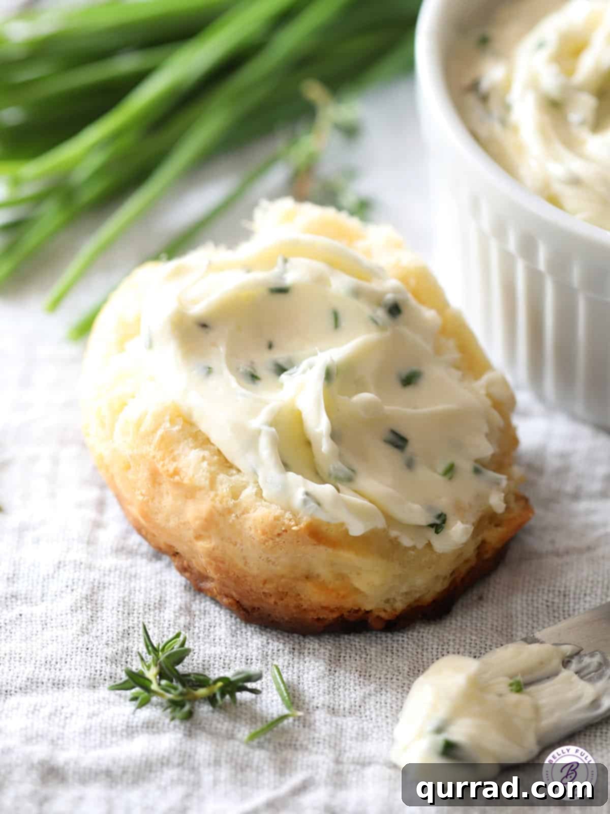 whipped herb butter spread generously on a warm dinner roll