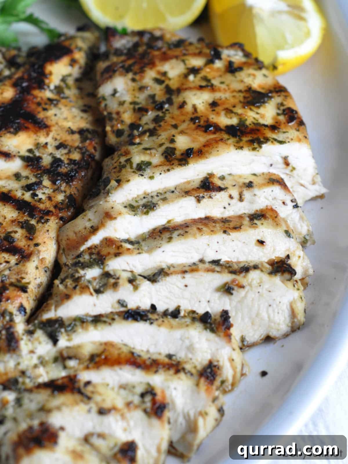 Juicy Grilled Chicken Breasts 5 Perfectly sliced grilled chicken breast arranged on a plate.