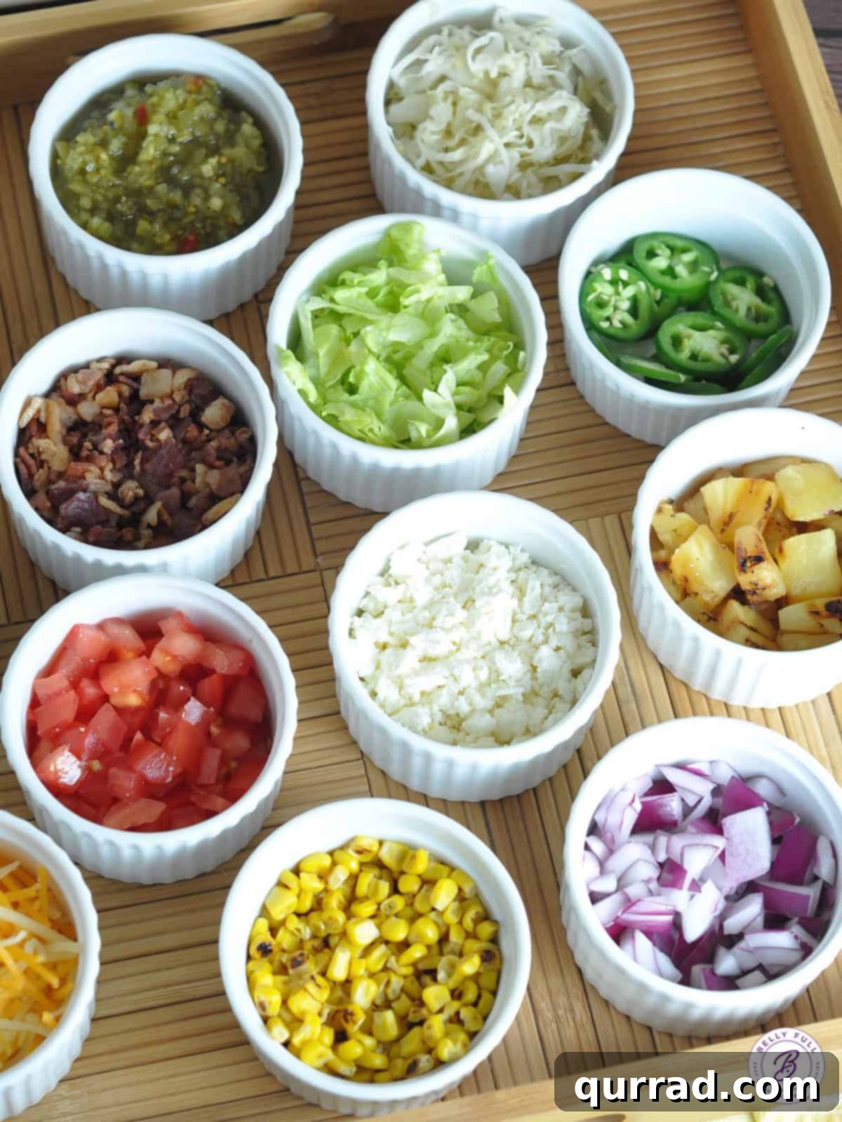 Frank & Fixings 3 Bowls of various fresh and savory toppings for grilled hot dogs, including corn, jalapeños, cheese, and grilled onions, laid out for a hot dog bar.