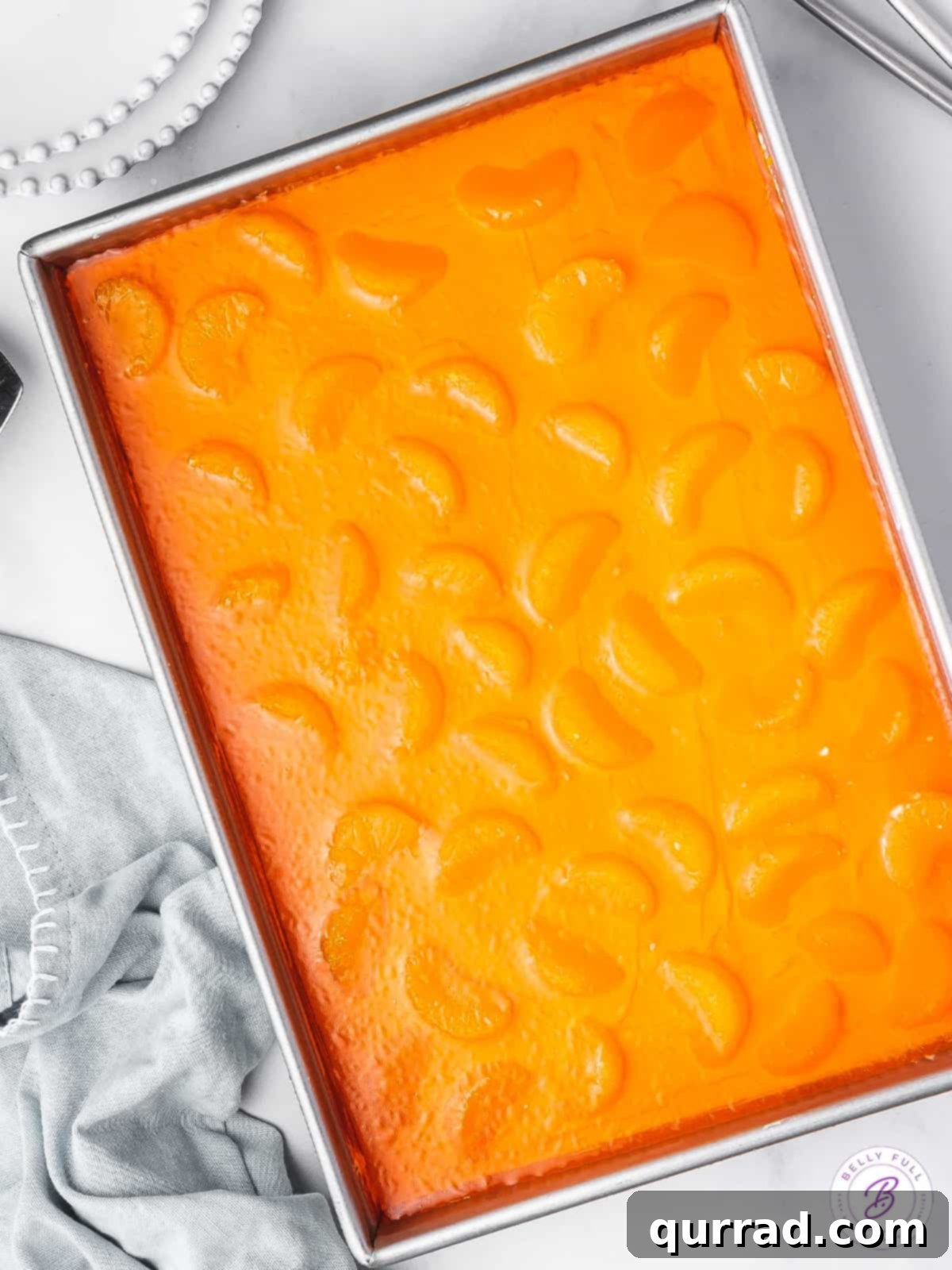 over head mandarin orange pretzel dessert casserole, showing the full dessert in a baking dish