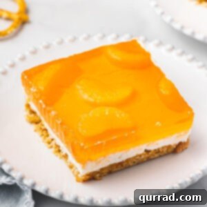 square portion of orange pretzel dessert on white plate