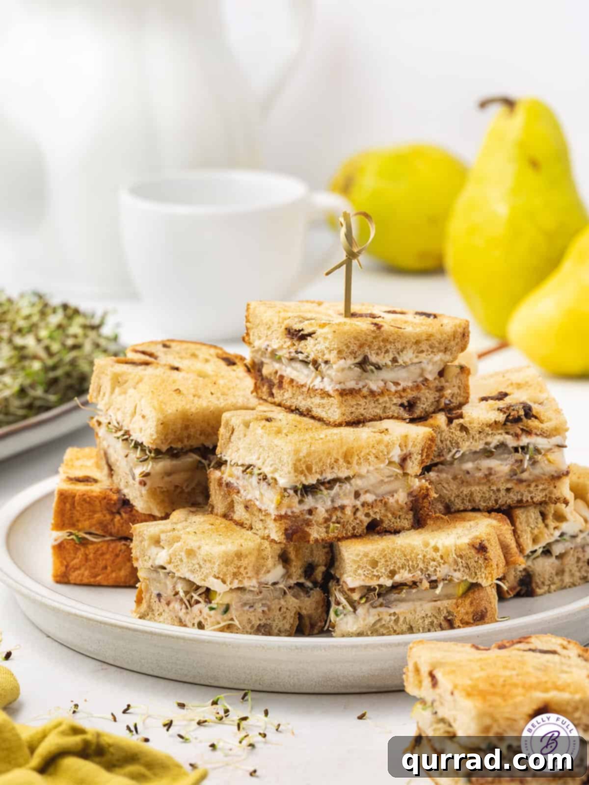 Delicate Pear Tea Bites 5 tea sandwiches on plate with toothpicks