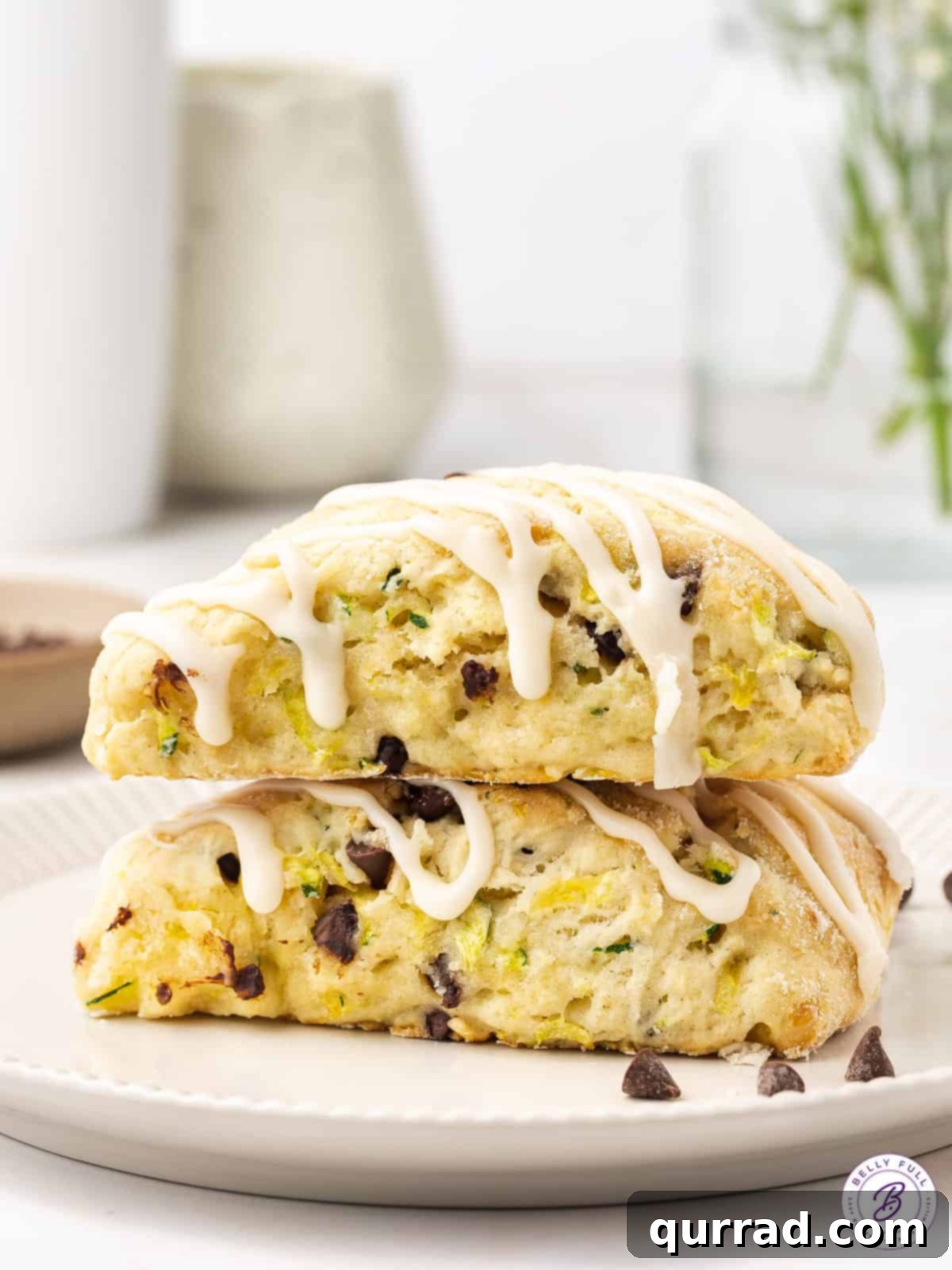 Tender Zucchini Chocolate Chip Scones 4 Two stacked chocolate chip zucchini scones, revealing the green specks of zucchini and melted mini chocolate chips inside.