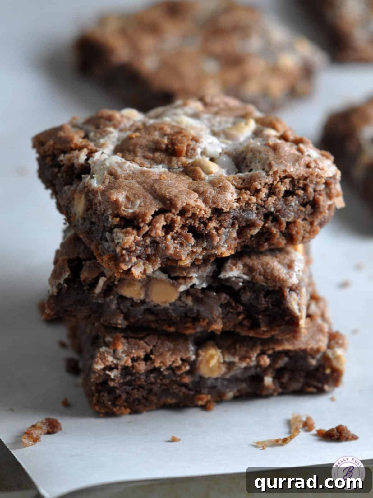 A stack of three decadent German Chocolate Gooey Bars, highlighting their layers and tempting texture.