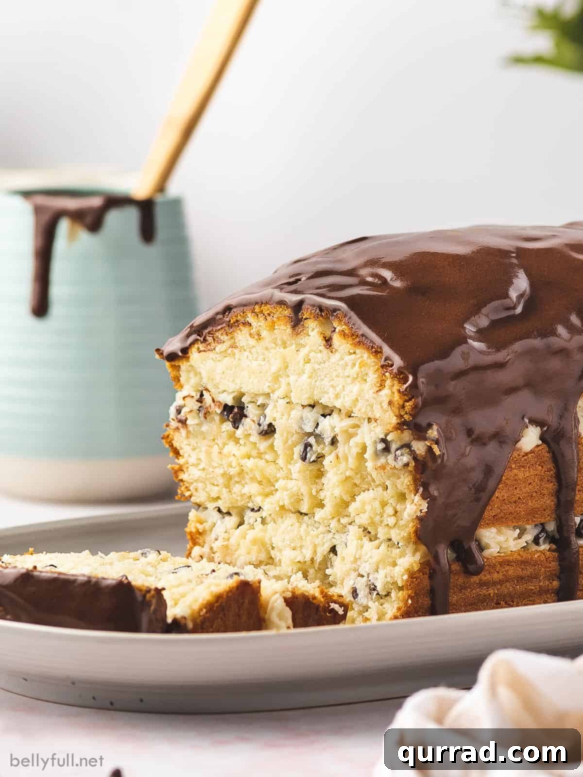 Divine Coconut Chocolate Layered Pound Cake 2 Sliced Coconut Layered Pound Cake with Chocolate Ganache Drizzle, showcasing creamy coconut and mini chocolate chip filling