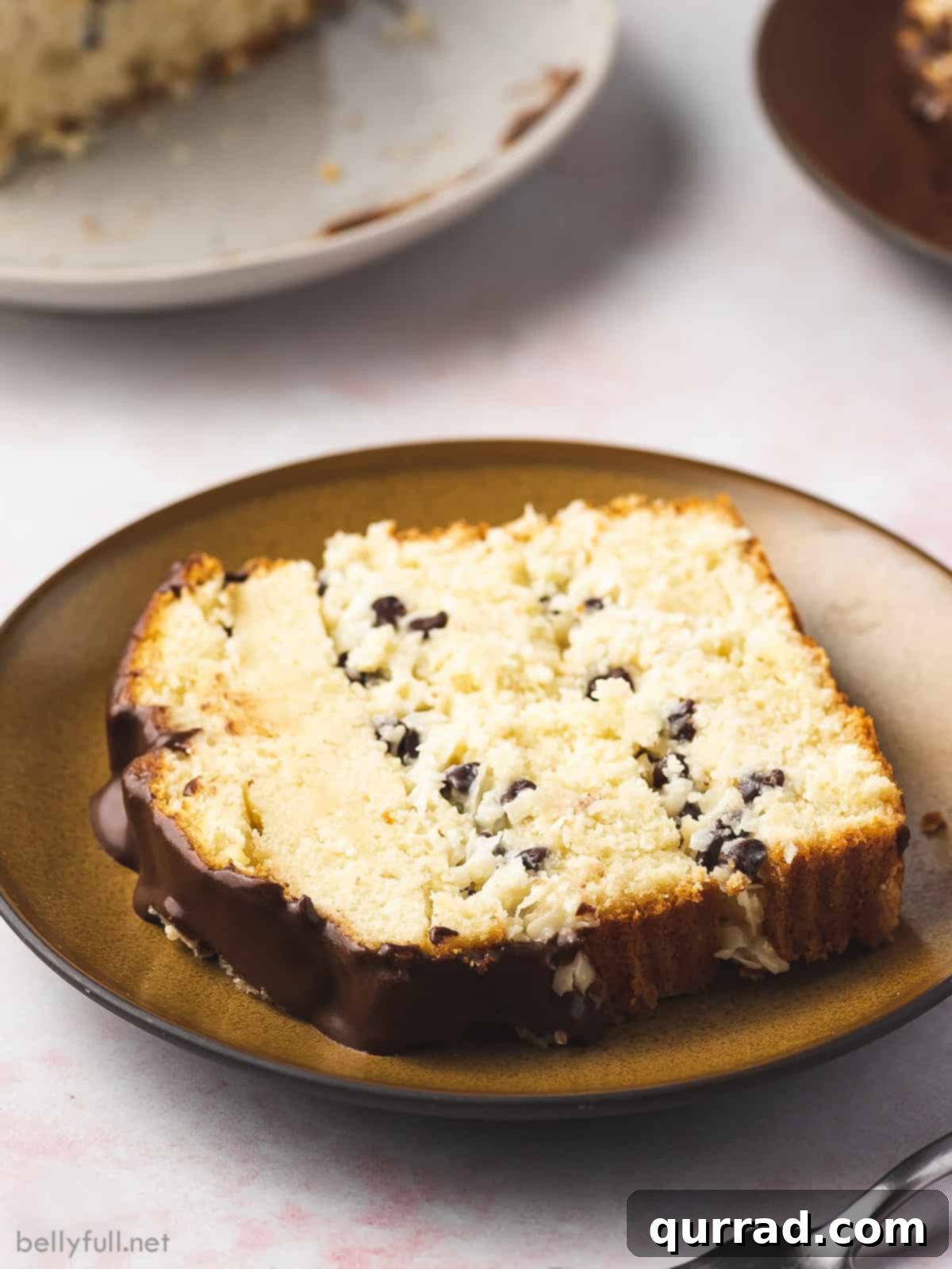 Divine Coconut Chocolate Layered Pound Cake 4 A perfectly portioned slice of Coconut-Chocolate Layered Pound Cake on a rustic brown plate, showing defined layers