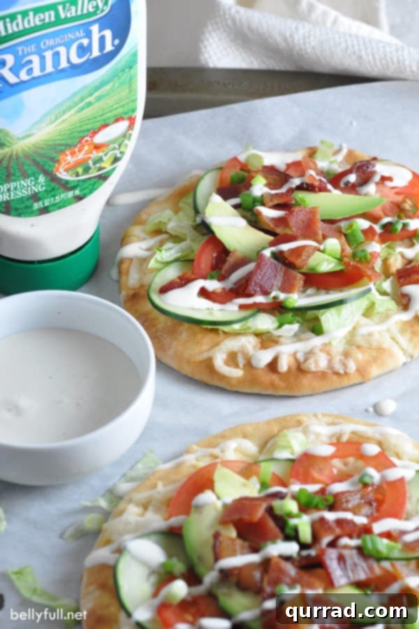 Close-up of a freshly made Ranch BLT Flatbread, showing layers of ingredients.