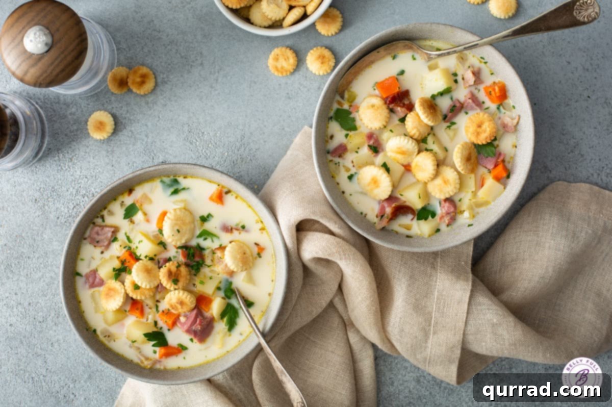 Hearty Ham and Potato Chowder 4 overhead of 2 bowls with ham and potato soup with oyster crackers
